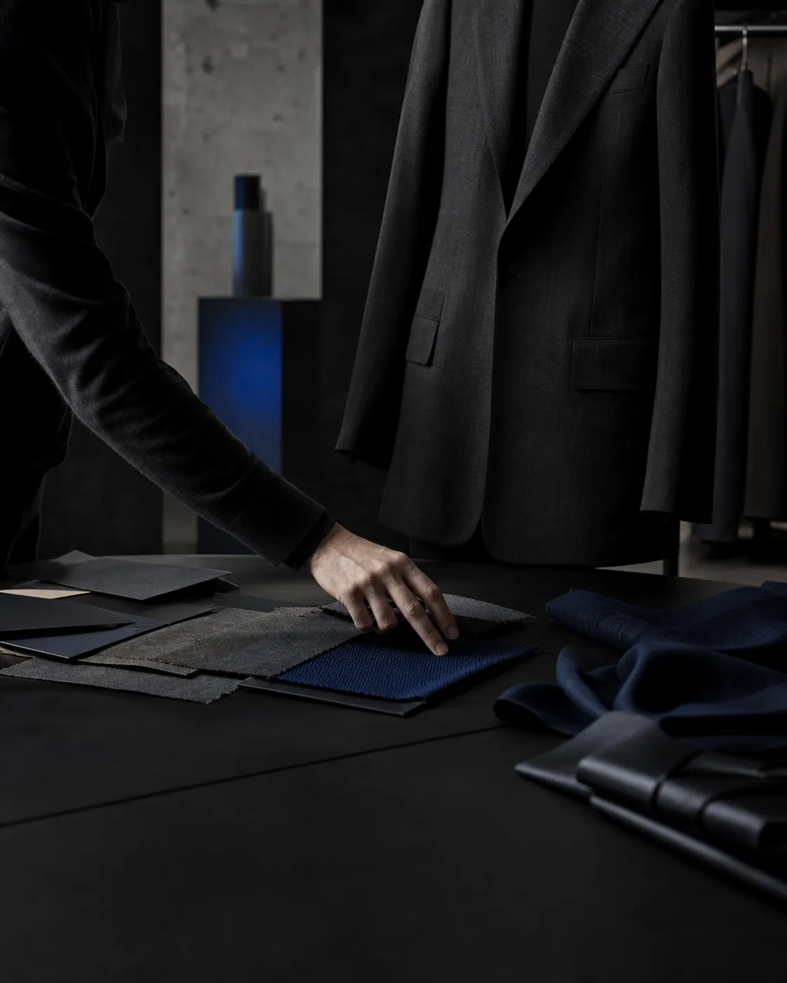 A fashion consultant selecting textile swatches beside a tailored jacket